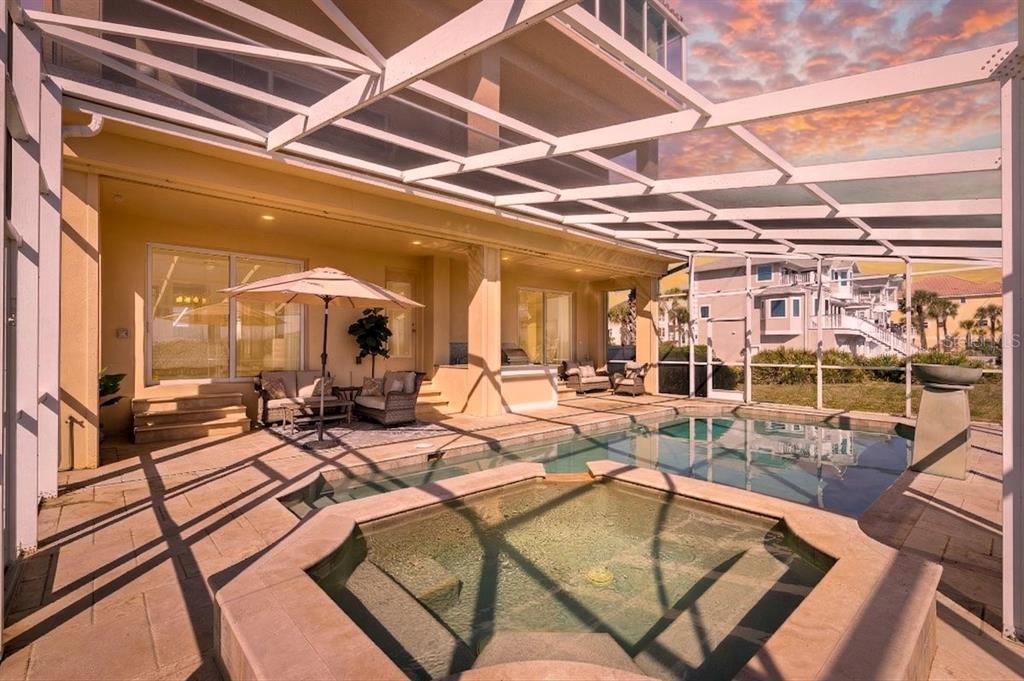 A screened-in patio features a swimming pool, a hot tub, and outdoor seating — 11 OCEAN DUNE CIRCLE, PALM COAST, FL