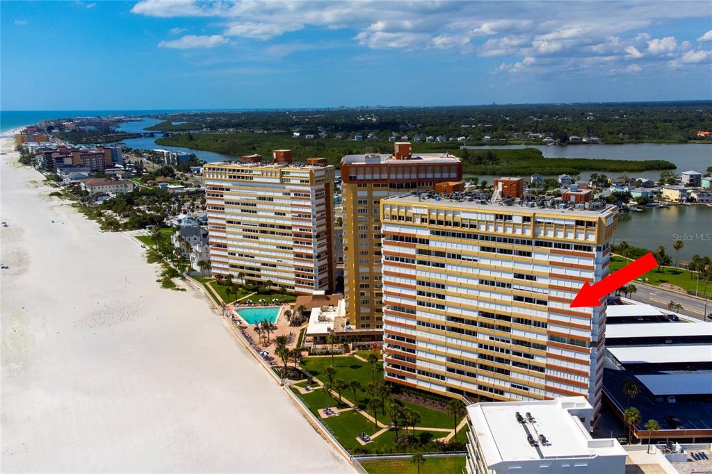 An aerial view shows two tall beachfront condominium buildings with parking lots and the ocean — 17900 GULF BOULEVARD UNIT 11C, REDINGTON SHORES, FL