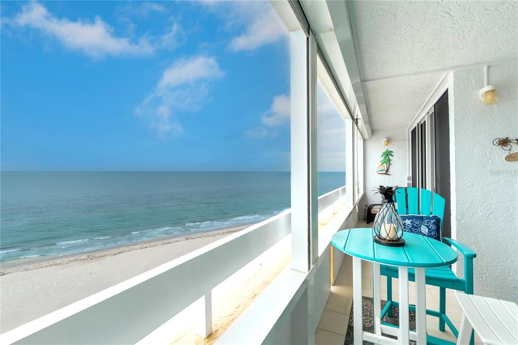 A hallway with white tile floors, a woven rug, and light blue walls leads forward — 17900 GULF BOULEVARD UNIT 11C, REDINGTON SHORES, FL