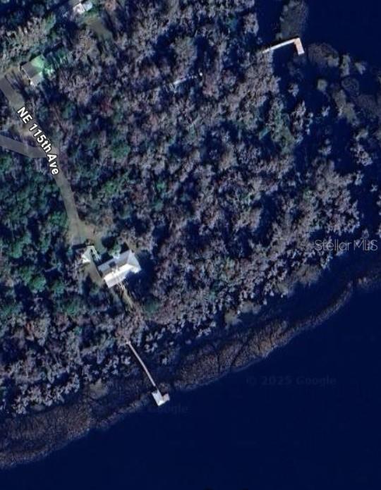 This aerial map view shows a waterfront house with a dock and a private driveway — 21779 NE 115TH AVENUE, EARLETON, FL