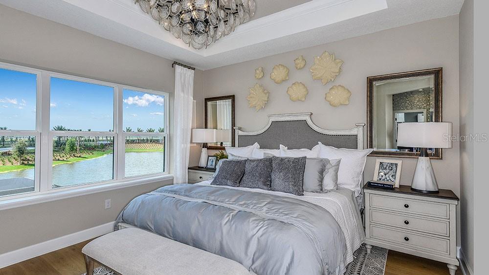 A living room features a sectional sofa, a television on a console, and large windows — 10836 ECLIPSE STREET, SARASOTA, FL