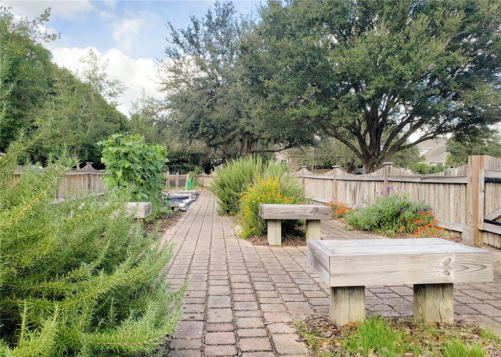 A brick path leads through a garden with wooden benches and a wooden fence — 13485 SW 9TH ROAD, NEWBERRY, FL