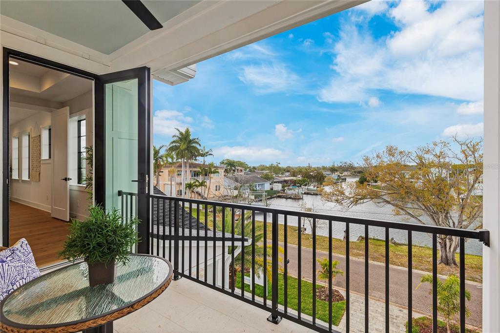 A spacious open-concept living and kitchen area features light wood flooring and a ceiling fan — 220 90TH AVENUE NE, ST PETERSBURG, FL