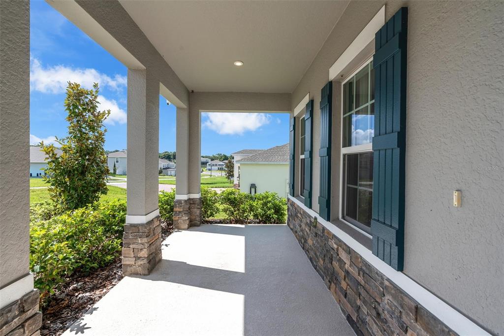 A bathroom features a double vanity with white cabinets, gray walls, and a glass shower — 3009 ROBLES ROAD, CLERMONT, FL