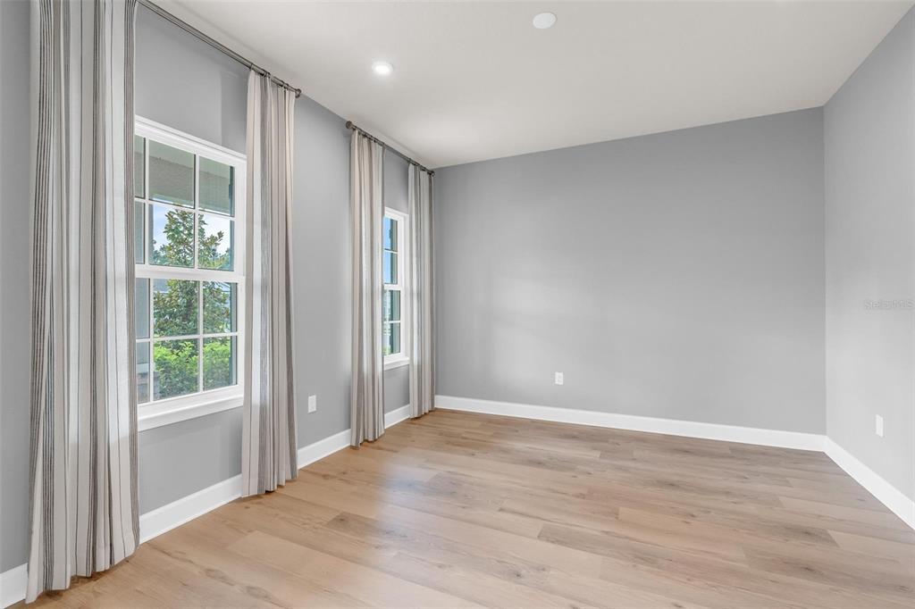 A hallway features light wood flooring, a wooden console table, and a glass-paneled entry door — 3009 ROBLES ROAD, CLERMONT, FL