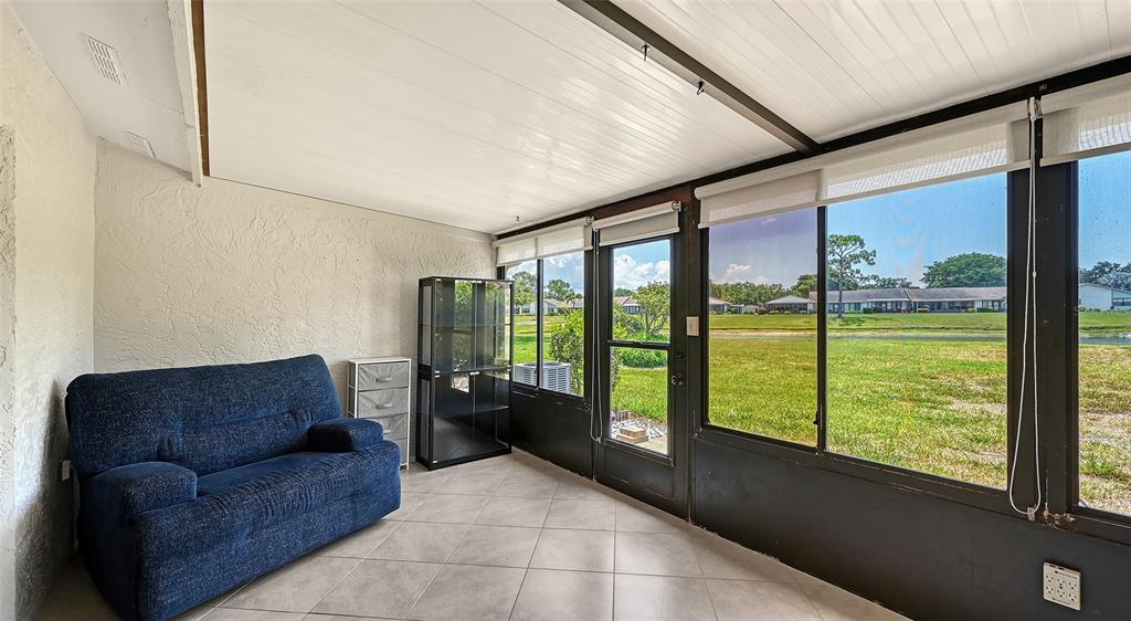An aerial view shows a residential complex with a pond and a circled unit — 6129 HERITAGE LANE W UNIT 6129, BRADENTON, FL