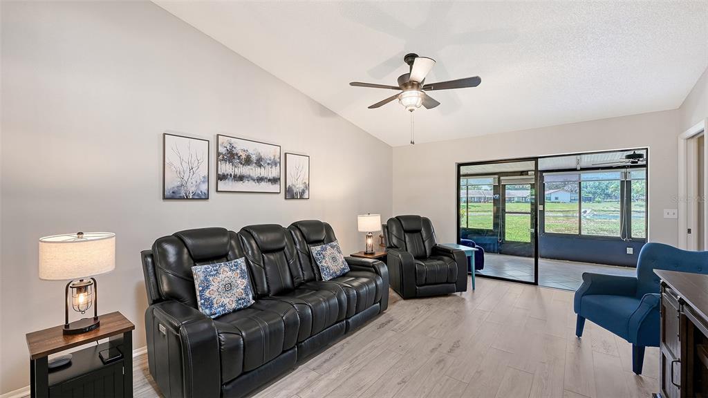 An aerial view shows a residential complex with a central pond and parking areas — 6129 HERITAGE LANE W UNIT 6129, BRADENTON, FL