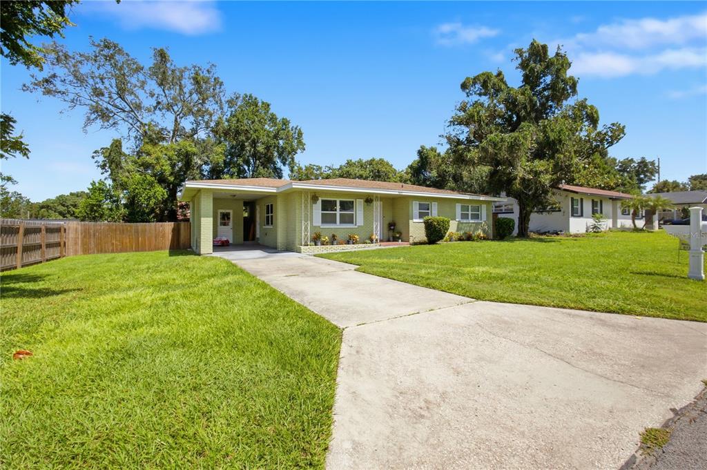 A kitchen features white cabinetry, stainless steel appliances, granite countertops, and a central island — 345 CANNON STREET, LAKELAND, FL
