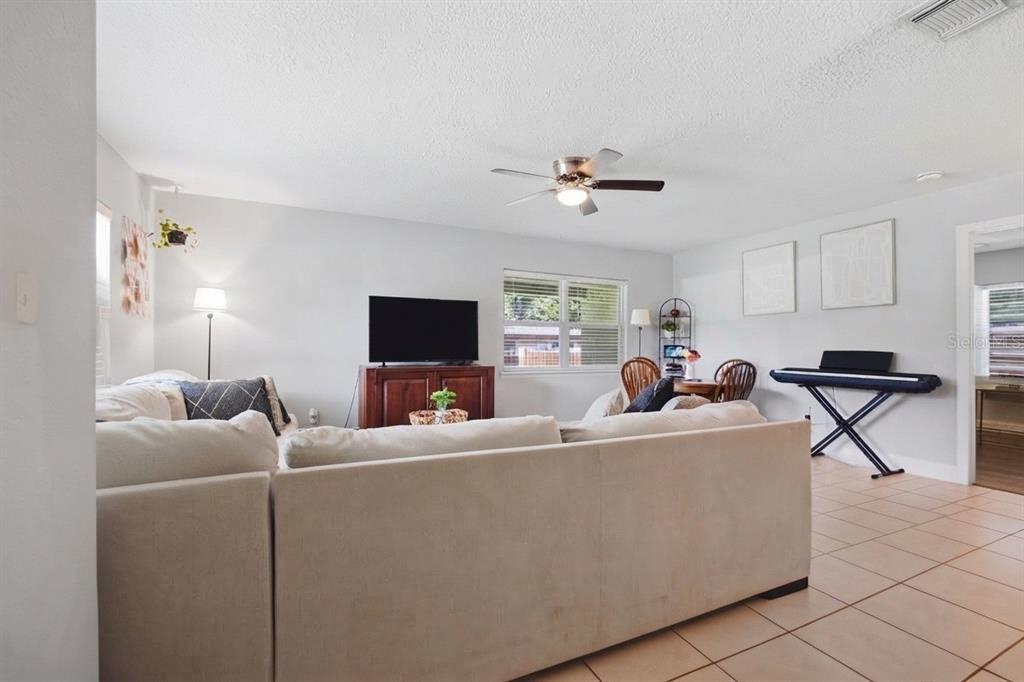 A kitchen features white cabinets, granite countertops, stainless steel appliances, and a window above the sink — 345 CANNON STREET, LAKELAND, FL