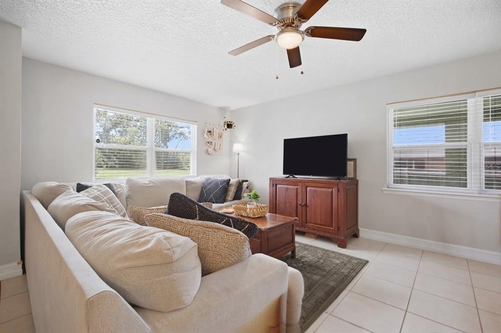 A white clawfoot bathtub sits against a wall with white subway tile and dark flooring — 345 CANNON STREET, LAKELAND, FL