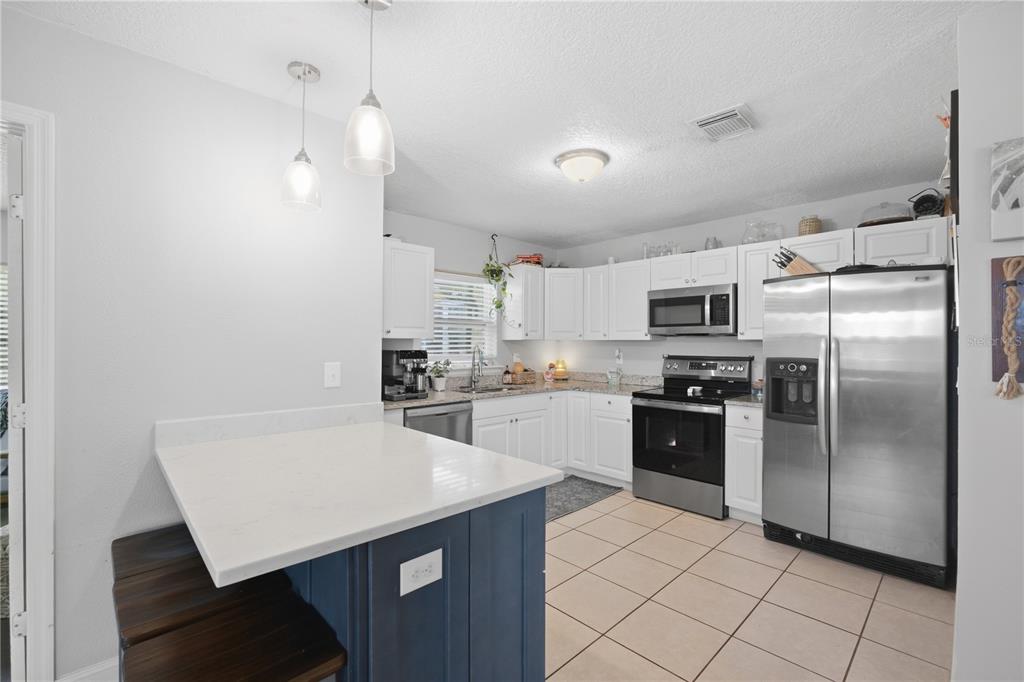 A bathroom features a glass-enclosed shower, white subway tile walls, and a clawfoot tub — 345 CANNON STREET, LAKELAND, FL