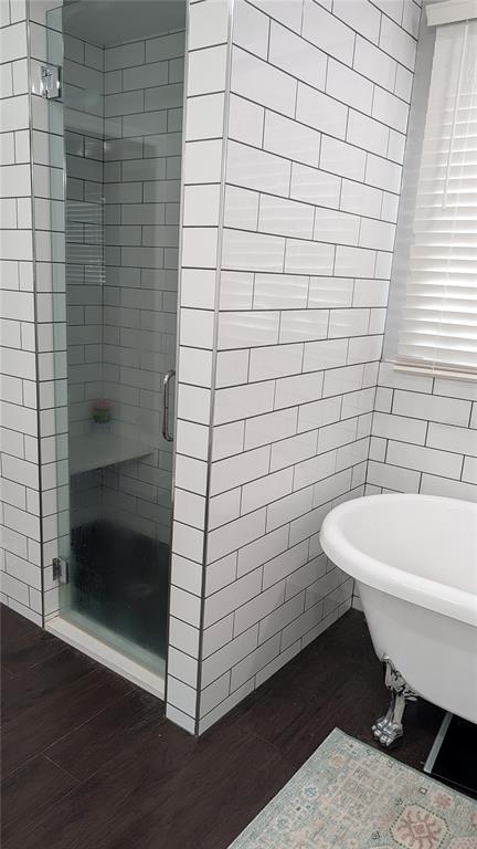 A bathroom features a glass-enclosed shower, white subway tile walls, and a clawfoot tub — 345 CANNON STREET, LAKELAND, FL