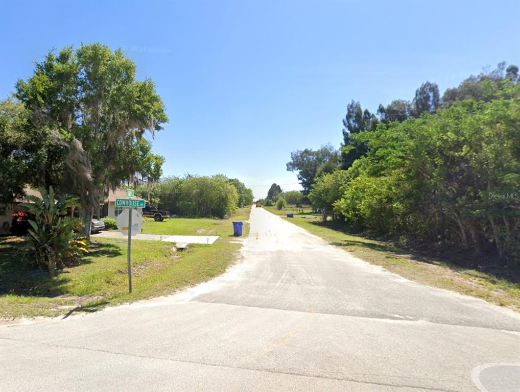 A street sign for Cowhouse Road stands at the corner of a rural paved road — 2733 TAWNY DRIVE, LORIDA, FL
