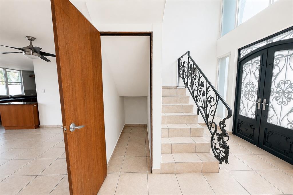 An open-concept living and dining area features tile flooring, two ceiling fans, and sliding doors — Estancias de Cerro Gordo N CALLE NINOSHKA UNIT B-12, VEGA ALTA, PR