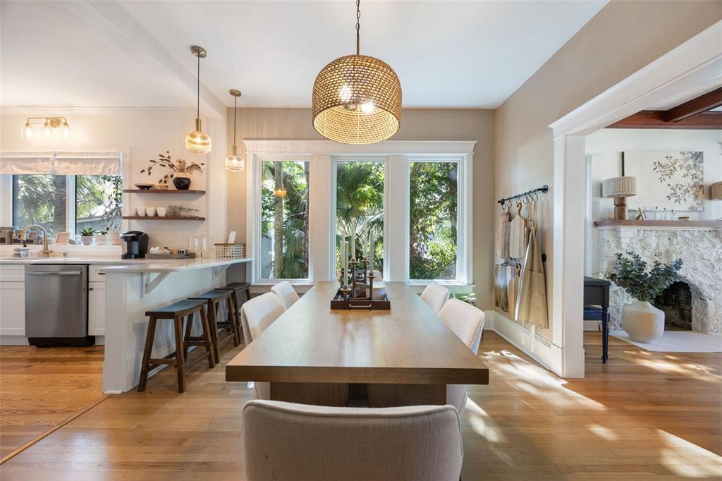 A dining room with a wooden table, upholstered chairs, and a woven pendant light fixture — 1473 BARCELONA AVENUE, FORT MYERS, FL