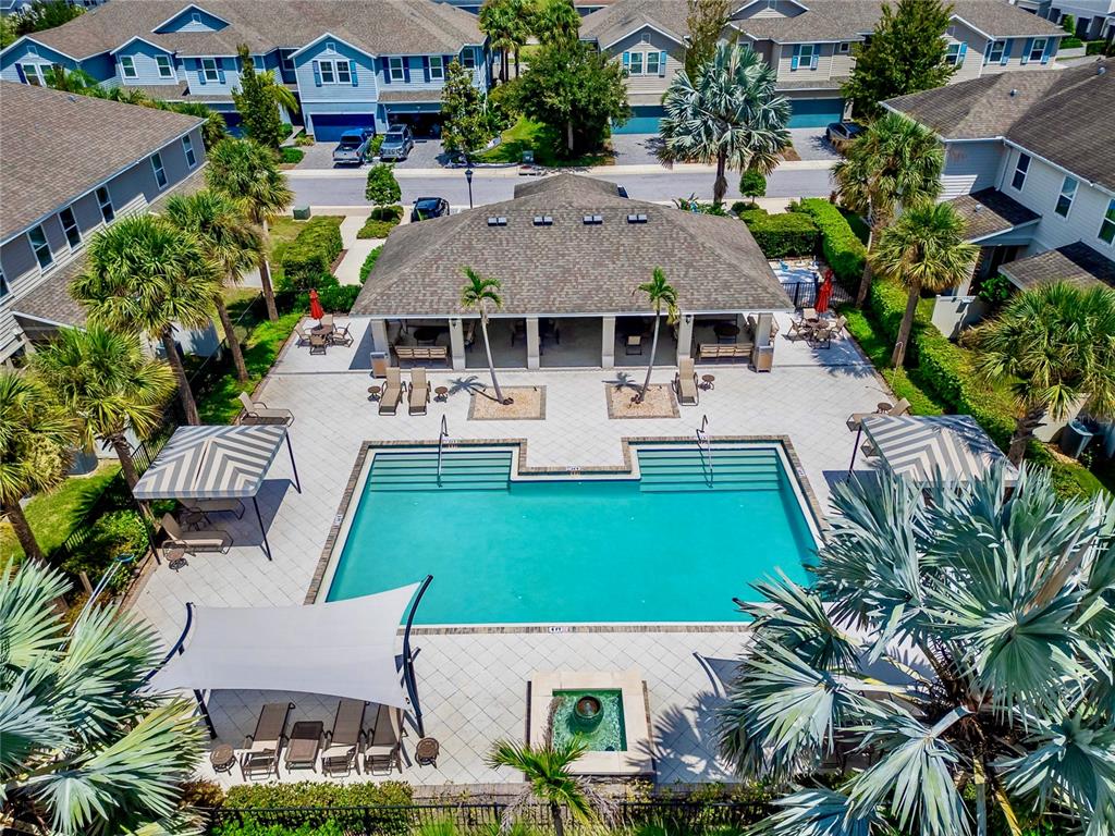 An aerial view of a community swimming pool with a covered patio and lounge chairs — 15037 ABBY BIRCH PLACE, TAMPA, FL