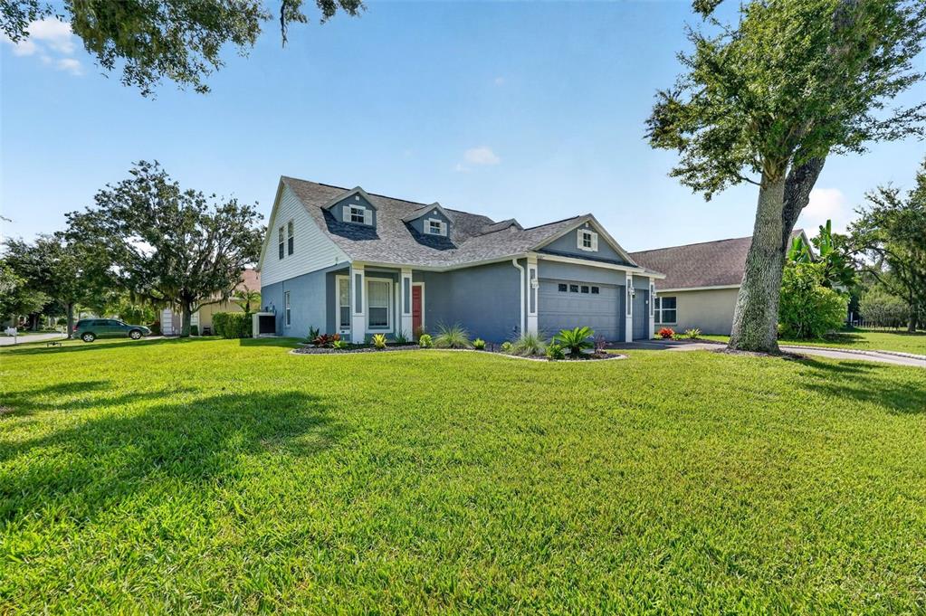 A two-story house with a gray exterior, a two-car garage, and a large front lawn — 4007 34TH STREET E, BRADENTON, FL