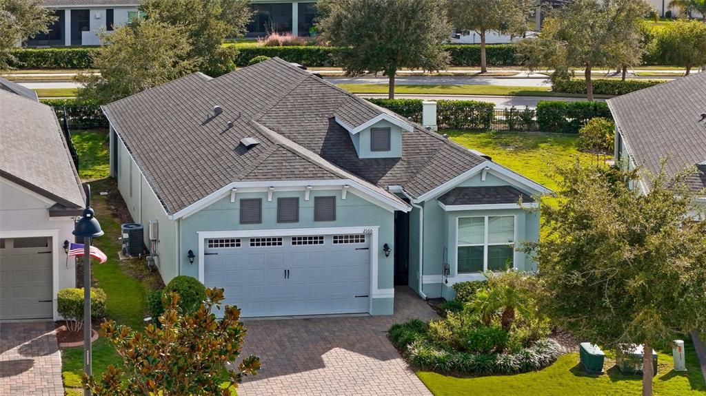 An aerial view of a light blue single-story house with a gray shingled roof — 2160 ANTILLES CLUB DRIVE, KISSIMMEE, FL