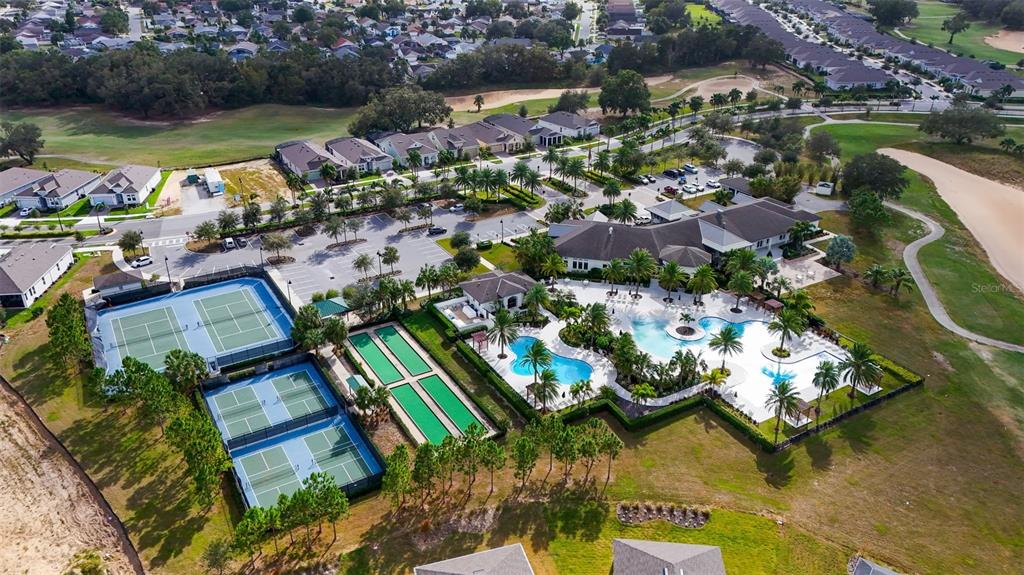 An aerial view shows a community clubhouse with a swimming pool and several tennis courts — 2160 ANTILLES CLUB DRIVE, KISSIMMEE, FL
