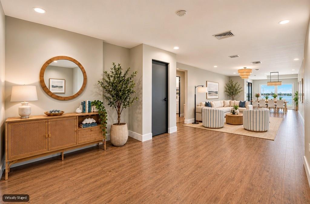 A modern kitchen features a large dark wood island, light gray cabinetry, and stainless appliances — 303 N BATH CLUB BOULEVARD N, NORTH REDINGTON BEACH, FL