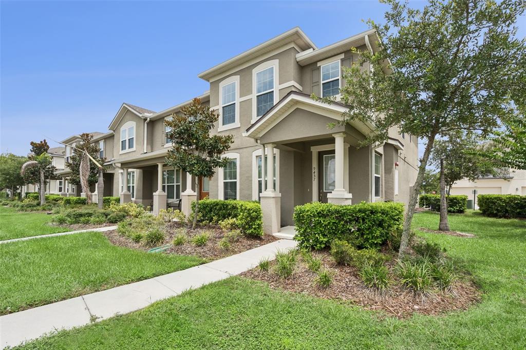 A kitchen with dark wood cabinets, granite countertops, and stainless steel appliances opens to dining — 9457 RANDAL PARK BOULEVARD, ORLANDO, FL