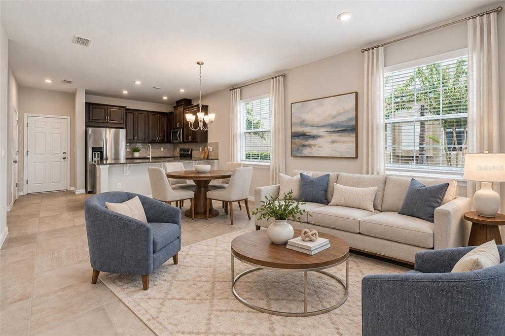A bedroom with a tray ceiling, gray carpet, and an attached bathroom with a shower — 9457 RANDAL PARK BOULEVARD, ORLANDO, FL