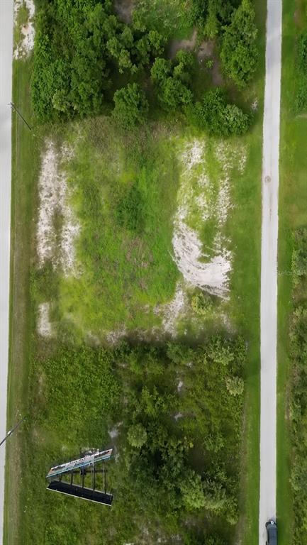 An aerial view shows a vacant, partially cleared rectangular lot with trees and a billboard — 8540 & 8546 & 8552 WILTSHIRE DRIVE, PORT CHARLOTTE, FL