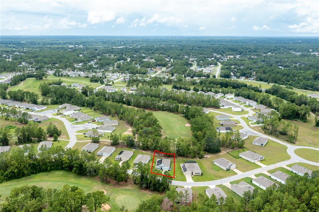 An aerial view shows a single-family home outlined in red within a suburban golf course community — 216 HICKORY COURSE, OCALA, FL
