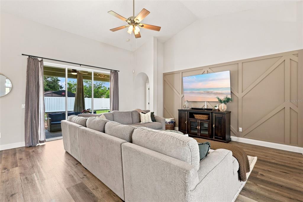 A bedroom features a tray ceiling, a large bay window, and dark wood furniture — 96 PARKVIEW DRIVE, PALM COAST, FL