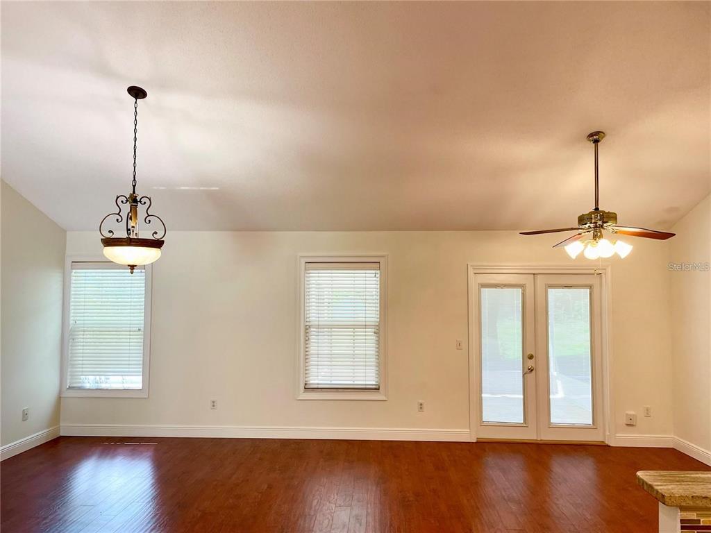 A room with hardwood floors, two windows with blinds, a ceiling fan, and French doors — 957 SOUTHRIDGE TRAIL, ALTAMONTE SPRINGS, FL