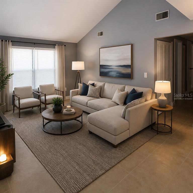 A kitchen features white cabinets, stainless steel appliances, a white subway tile backsplash, and countertops — 1019 PENINSULA ROAD, TARPON SPRINGS, FL