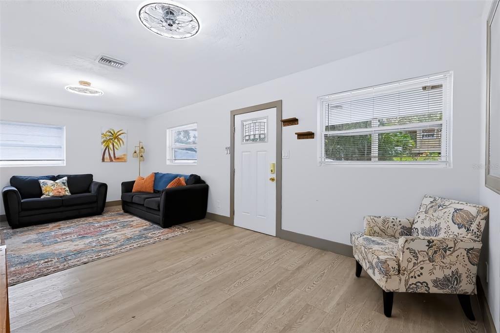 A covered patio features light green walls, a tiled floor, and a turquoise cabinet — 6691 56TH AVENUE N, ST PETERSBURG, FL