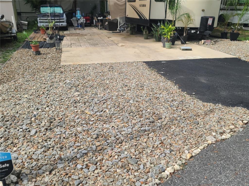 An exterior view shows two large recreational vehicles parked on a concrete pad and gravel — 25205 NE 142 ND STREET, SALT SPRINGS, FL
