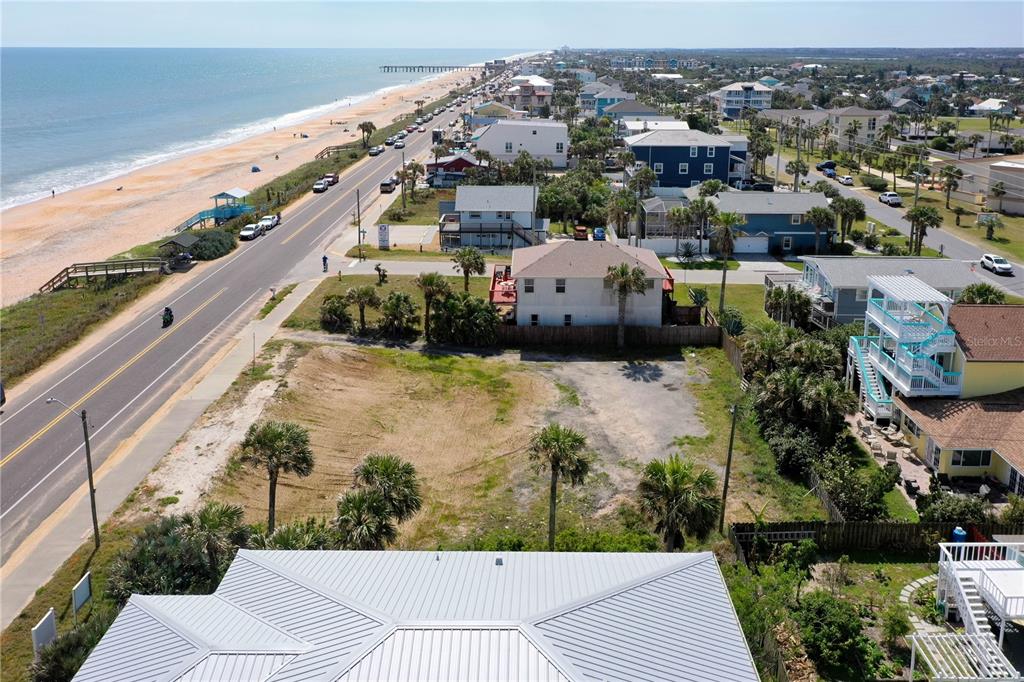 An aerial view shows a vacant coastal lot situated between a road and the ocean — 1005 N OCEAN SHORE BOULEVARD, FLAGLER BEACH, FL