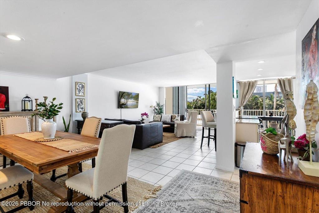 An open-concept living and dining area features white walls, tile flooring, and a balcony view — 2860 S OCEAN BOULEVARD UNIT 208, PALM BEACH, FL