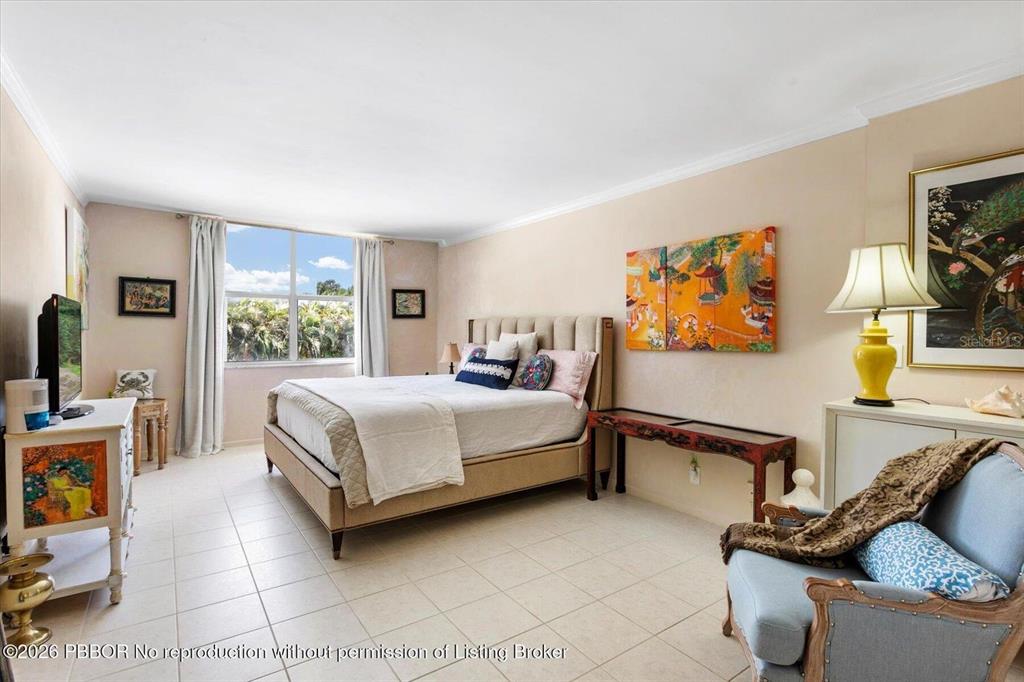 A bedroom with tile flooring, a bed, a window, and decorative wall art — 2860 S OCEAN BOULEVARD UNIT 208, PALM BEACH, FL