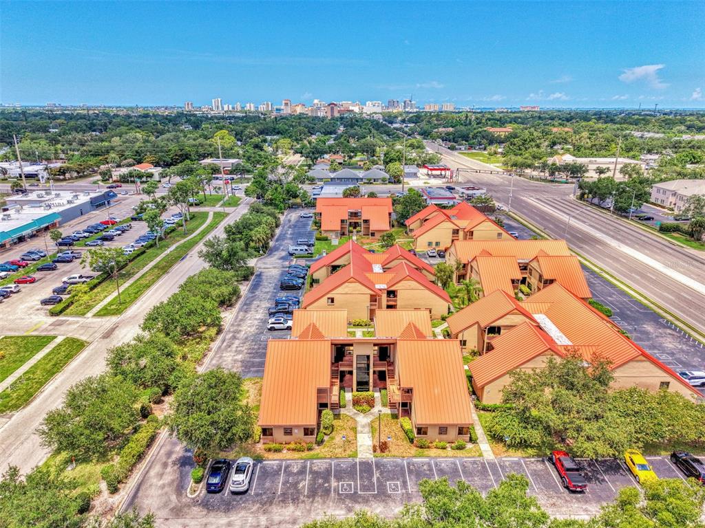 An aerial view shows a multi-building office complex with orange roofs and parking lots — 2831 RINGLING BOULEVARD UNIT E214, SARASOTA, FL