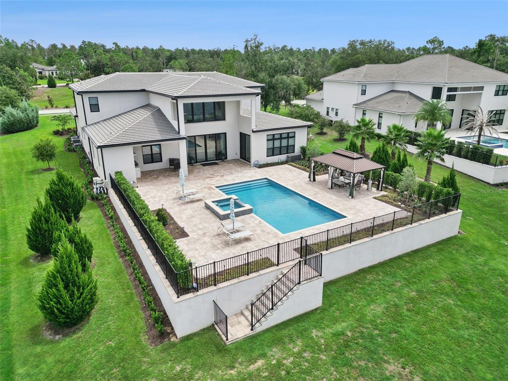 An aerial view of a two-story house with a pool, patio, and gazebo — 15421 PENDIO DRIVE, MONTVERDE, FL