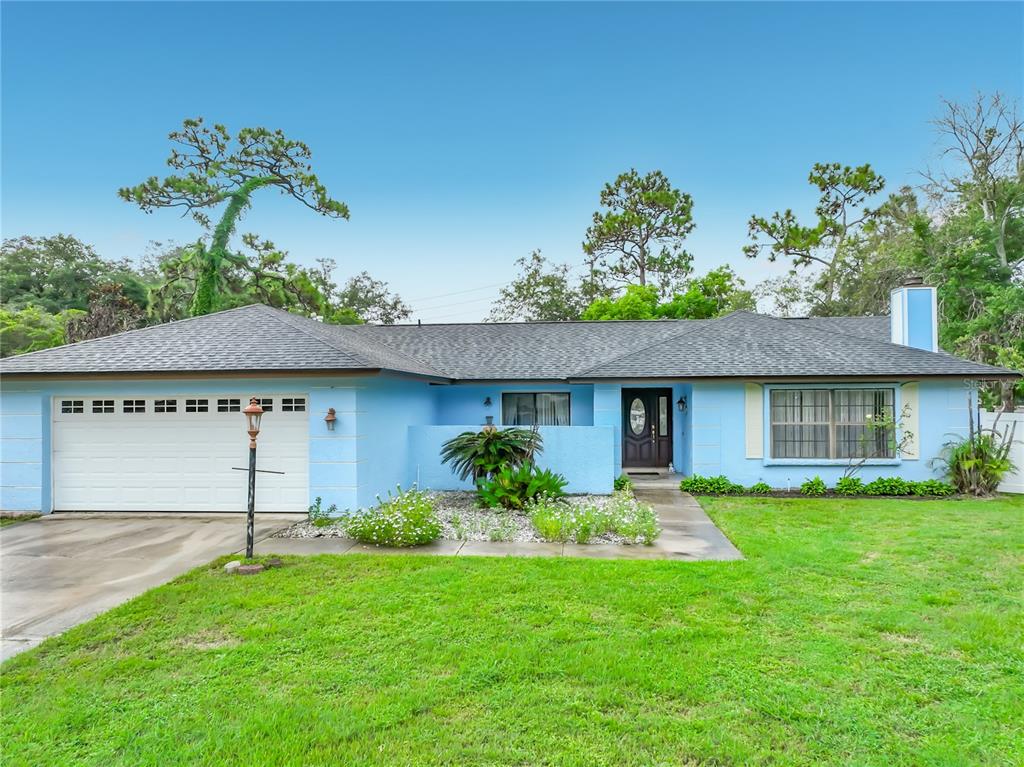 An aerial view shows a suburban neighborhood with houses, a road, and surrounding trees — 9216 AMITY COURT, ORLANDO, FL