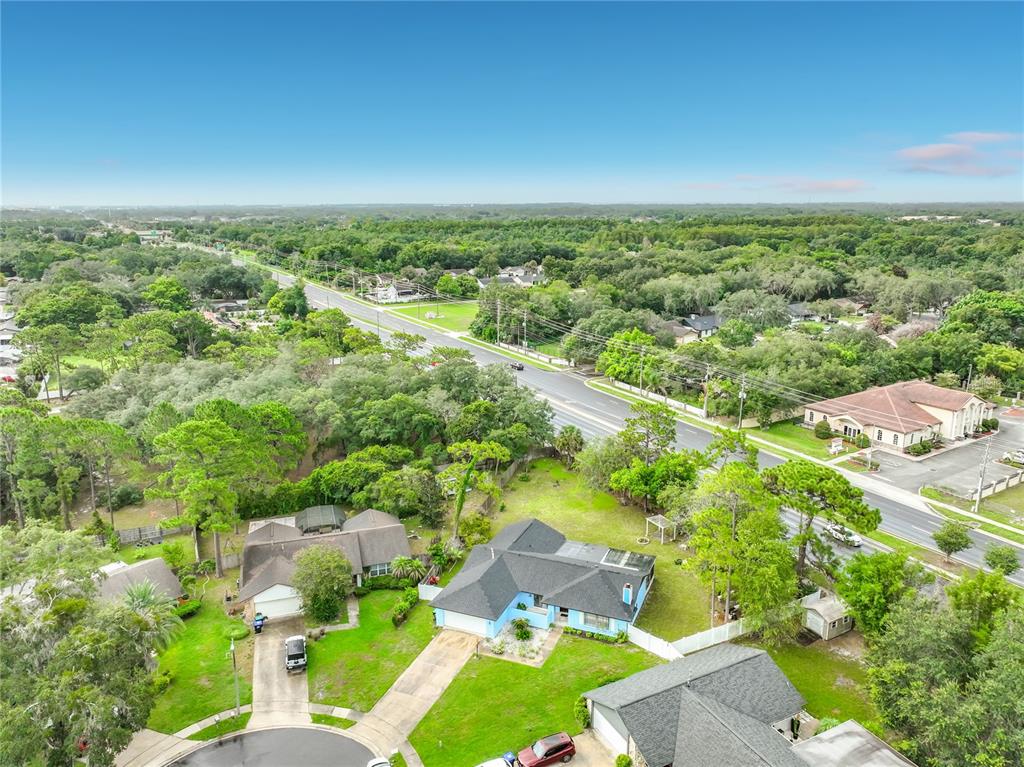 A single-story light blue house with a two-car garage and a front lawn — 9216 AMITY COURT, ORLANDO, FL