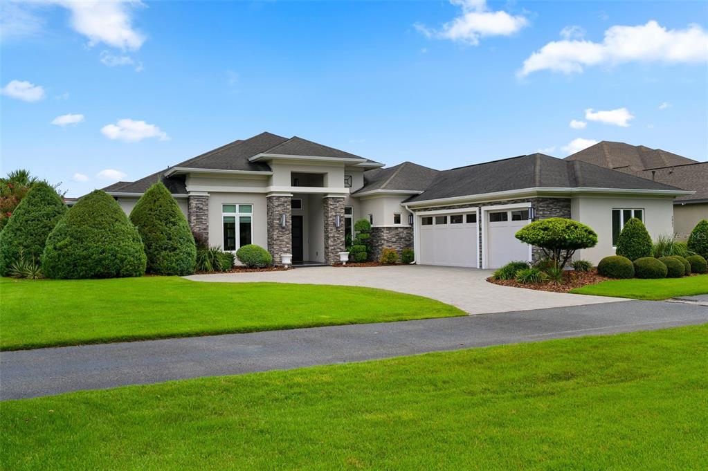 A single-story house with a stone facade, a two-car garage, and a manicured lawn — 2807 SW 117TH STREET, GAINESVILLE, FL