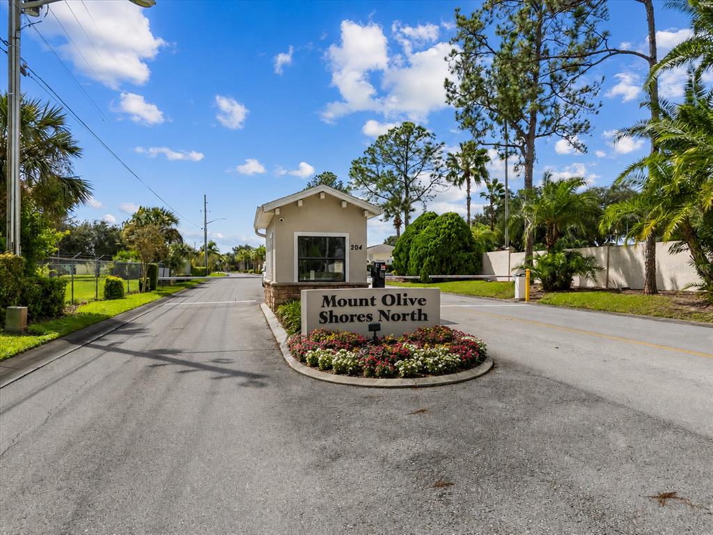 The entrance to Mount Olive Shores North features a guardhouse and a landscaped sign — 346 NOLANE LANE, POLK CITY, FL
