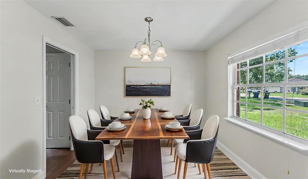 This dining room features a wooden table with eight chairs under a chandelier — 4520 OLD COLONY ROAD, MULBERRY, FL