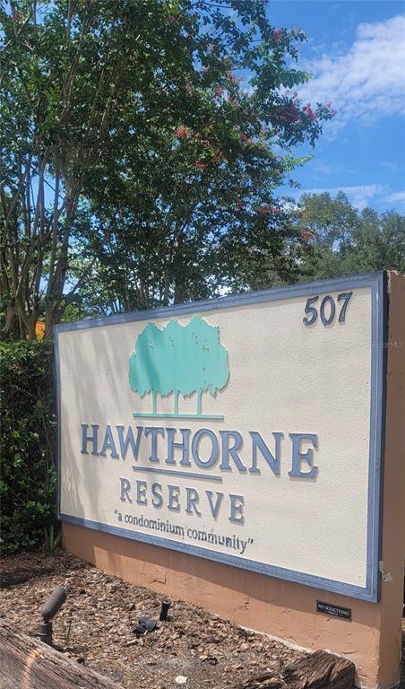 A sign for Hawthorne Reserve condominium community stands outdoors near a tree — 507 NW 39TH ROAD UNIT 122, GAINESVILLE, FL