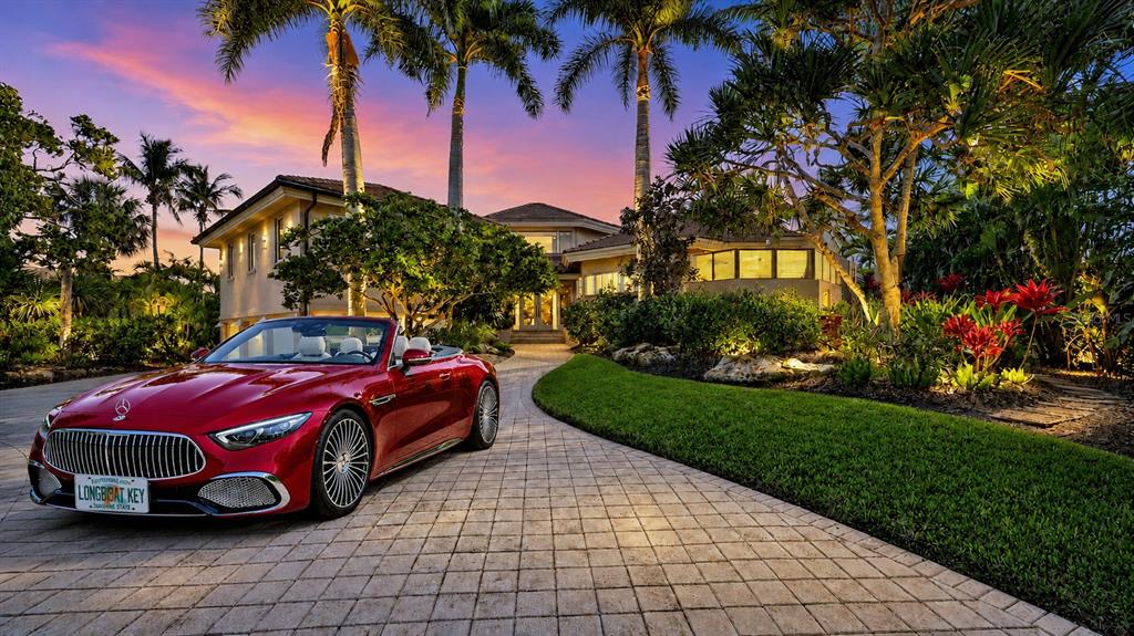 An aerial view shows a large multi-story house with a paved driveway and palm trees — 510 HARBOR GATE WAY, LONGBOAT KEY, FL