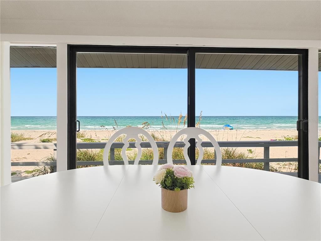 An aerial view shows a beachfront house circled among other coastal properties along the shore — 2823 GULF OF MEXICO DRIVE, LONGBOAT KEY, FL
