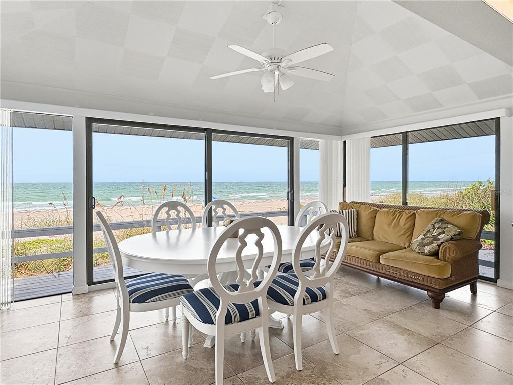 A wooden deck overlooks a sandy beach and ocean during a vibrant sunset — 2823 GULF OF MEXICO DRIVE, LONGBOAT KEY, FL