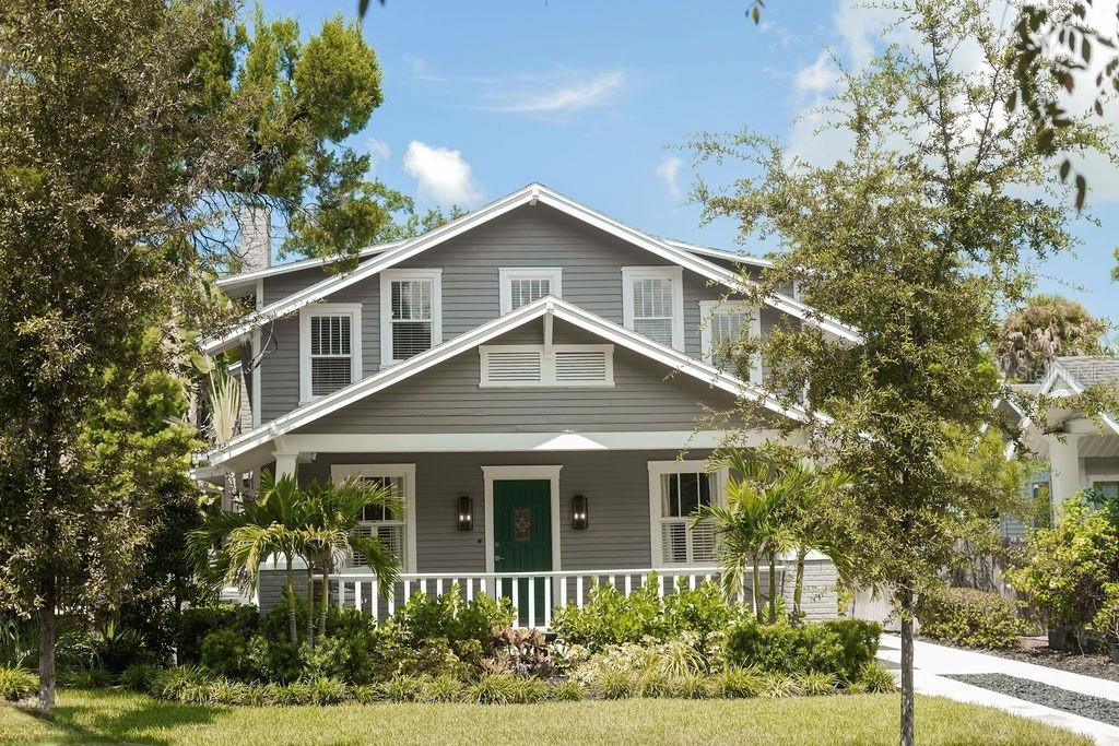 A backyard swimming pool with a stone patio, water features, and surrounding tropical landscaping — 605 S ORLEANS AVENUE, TAMPA, FL