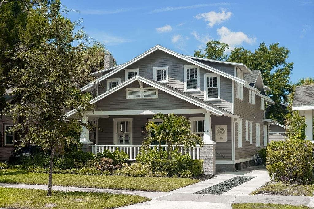 A backyard swimming pool with a fountain, stone deck, and a detached gray shed — 605 S ORLEANS AVENUE, TAMPA, FL