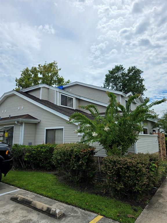 A two-story residential building with light-colored siding, a dark shingled roof, and surrounding landscaping — 3111 RIO GRANDE TRAIL, KISSIMMEE, FL